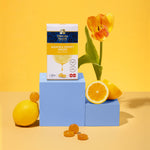Manuka Health Manuka Honey Drops packaging with lemons and a tulip on a yellow background