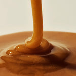 Manuka Health Manuka Honey MGO 800 being drizzled into a bowl.