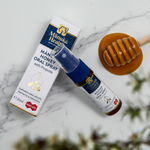 Manuka Health MGO 400+ Manuka Honey Oral Spray with Propolis on a marble surface.