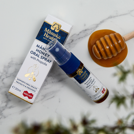 Manuka Health MGO 400+ Manuka Honey Oral Spray with Propolis on a marble surface.
