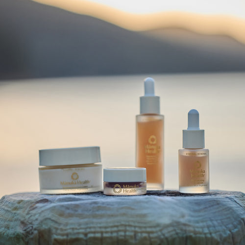 Manuka Health Eternal Renewal Collection on a piece of wood against the New Zealand sunset.  
