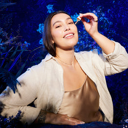 Woman Eternal Renewal Eye Serum against a blue floral background.